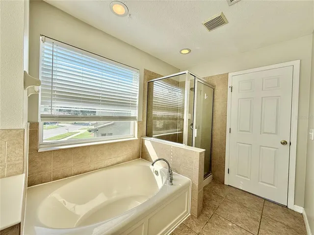a bathroom with a tub and a sink