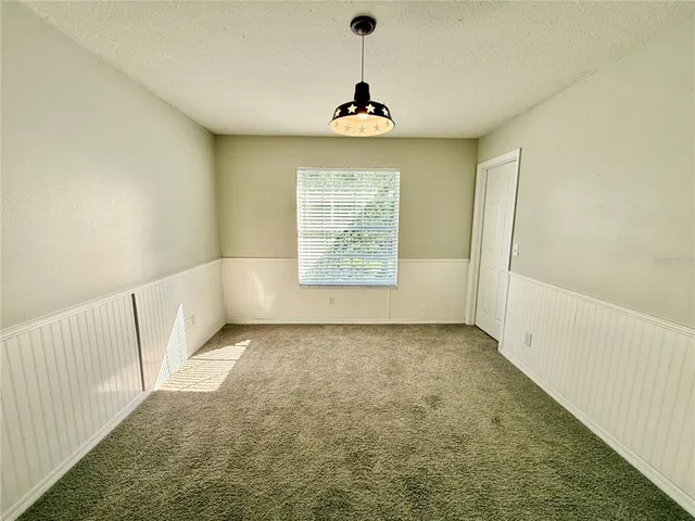 a view of an empty room and a window