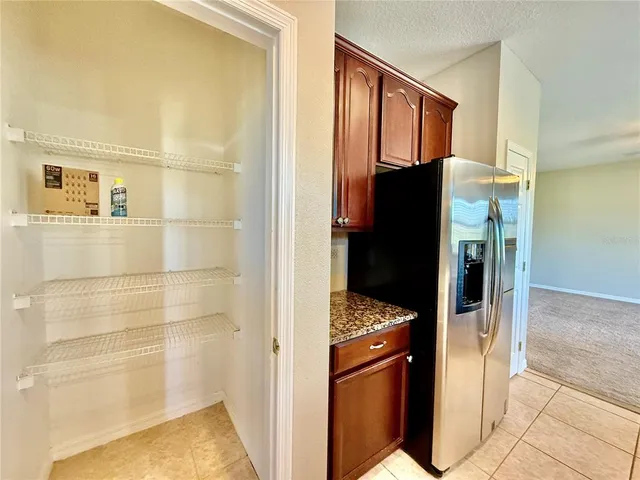 a view of a refrigerator in kitchen and wooden floor
