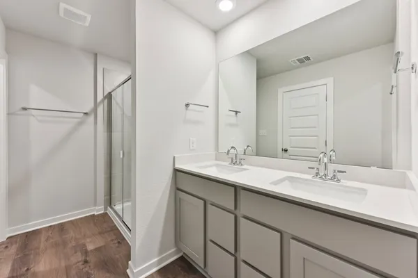 a bathroom with a double vanity sink and mirror