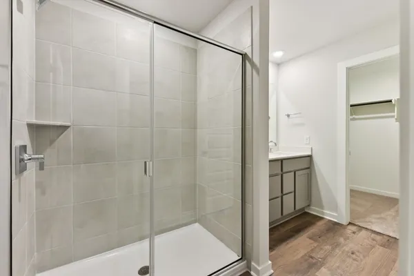 a bathroom with a shower and a sink