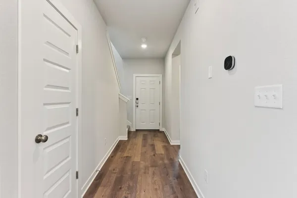 a view of a hallway with wooden floor