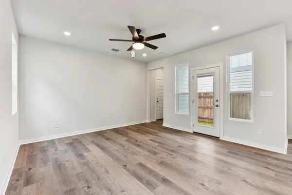 wooden floor in an empty room with a window