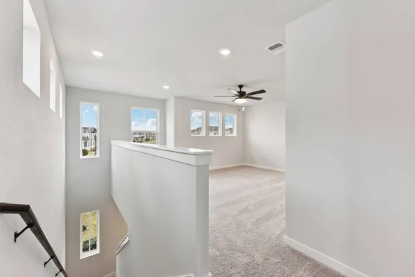 a view of a kitchen with furniture and a refrigerator