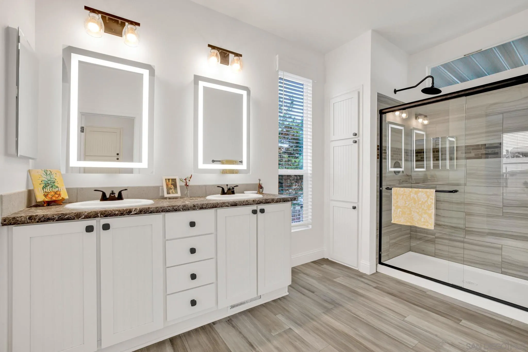 2515 Sweetwater Road, Unit 76 Spring Valley, CA 91977 - Photo 18 of 31 a bathroom with a double vanity sink and mirror