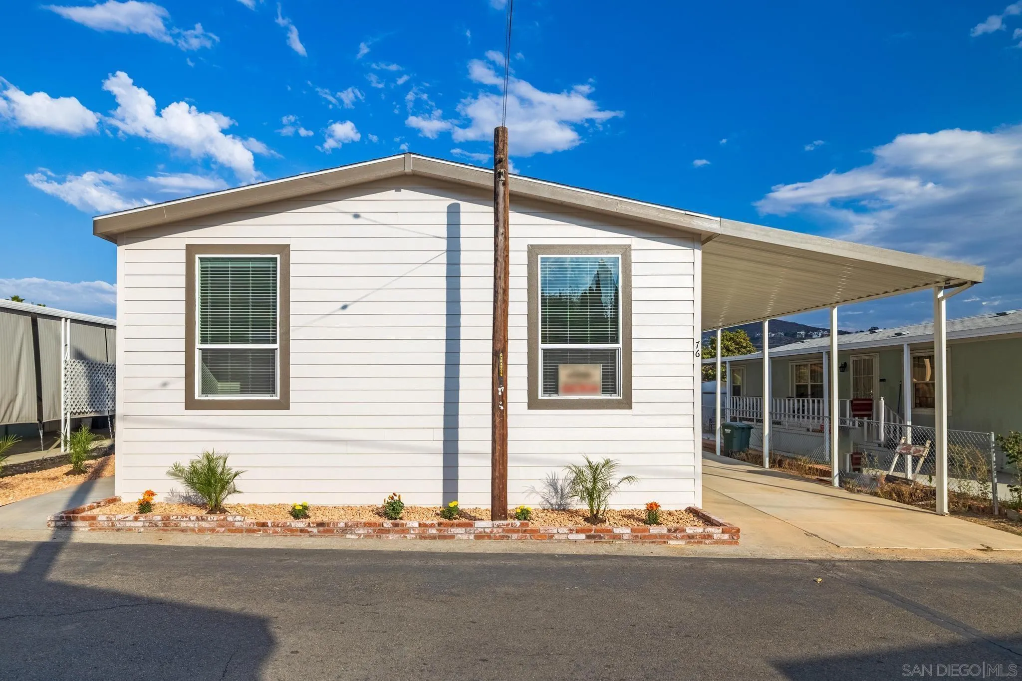 2515 Sweetwater Road, Unit 76 Spring Valley, CA 91977 - Photo 27 of 31 a front view of a house with a yard