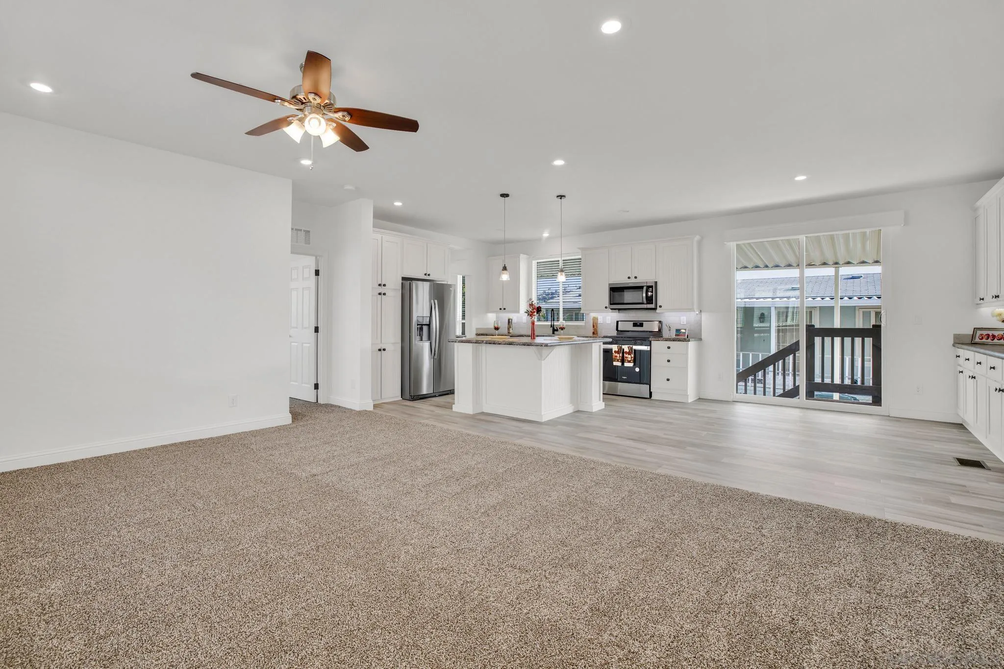 2515 Sweetwater Road, Unit 76 Spring Valley, CA 91977 - Photo 3 of 31 an empty room with kitchen and windows