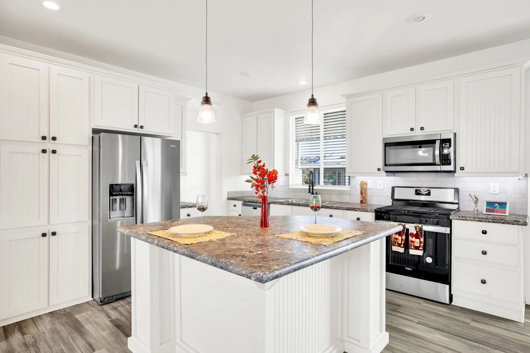 2515 Sweetwater Road, Unit 76 Spring Valley, CA 91977 - Photo 6 of 31 a kitchen with stainless steel appliances granite countertop a sink dishwasher a refrigerator and a stove