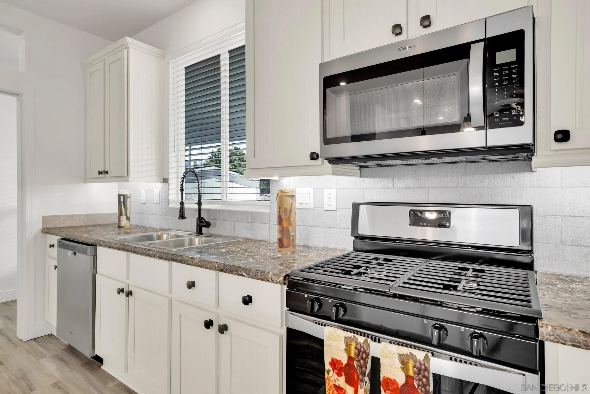 2515 Sweetwater Road, Unit 76 Spring Valley, CA 91977 - Photo 9 of 31 a kitchen with stainless steel appliances granite countertop a stove microwave and sink