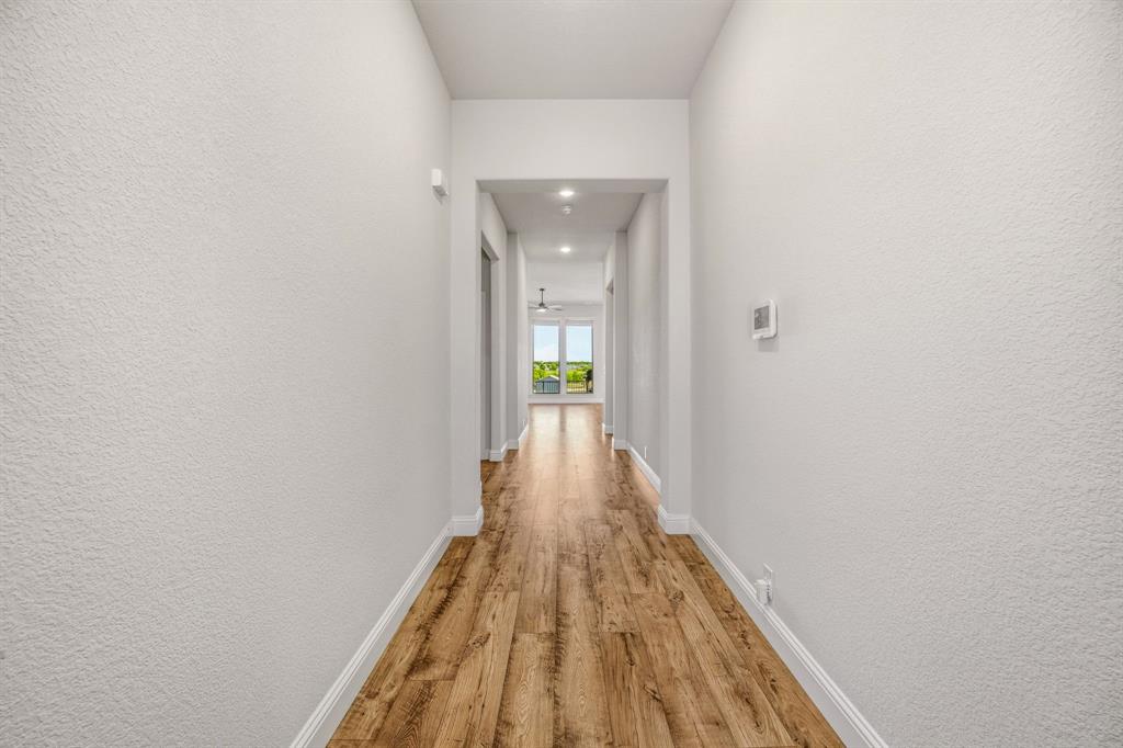 800 Jaguar Ridge Godley, TX 76044 - Photo 13 of 23 a view of a hallway with wooden floor