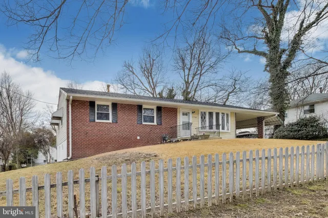 a front view of house with yard and trees
