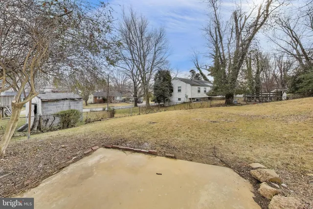 a view of a yard with snow on the road