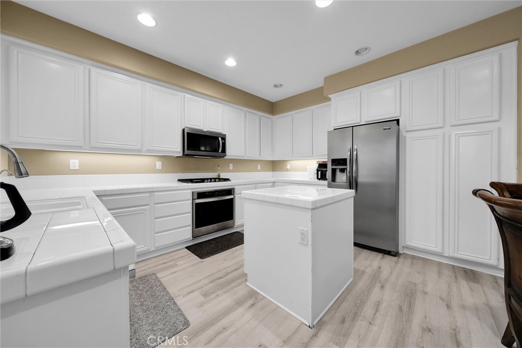 28440 Ware Street Murrieta, CA 92563 - Photo 18 of 72 a kitchen with a sink stove and refrigerator