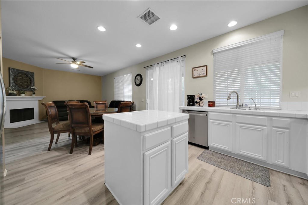 28440 Ware Street Murrieta, CA 92563 - Photo 21 of 72 a kitchen that has a lot of cabinets in it and wooden floors