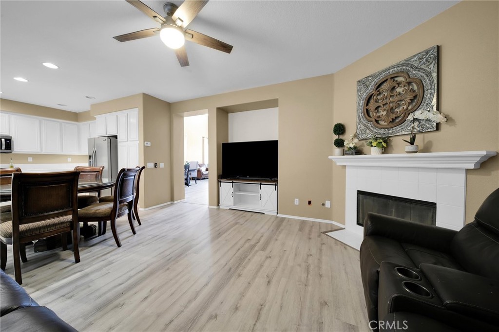 28440 Ware Street Murrieta, CA 92563 - Photo 24 of 72 a living room with furniture a flat screen tv and a fireplace