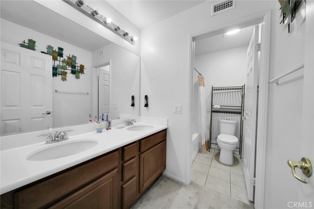 28440 Ware Street Murrieta, CA 92563 - Photo 33 of 72 a spacious bathroom with a double vanity sink and a mirror