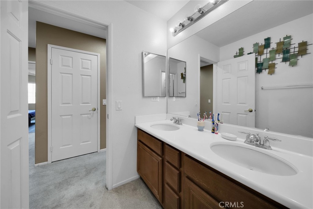 28440 Ware Street Murrieta, CA 92563 - Photo 35 of 72 a bathroom with a double vanity sink and mirror
