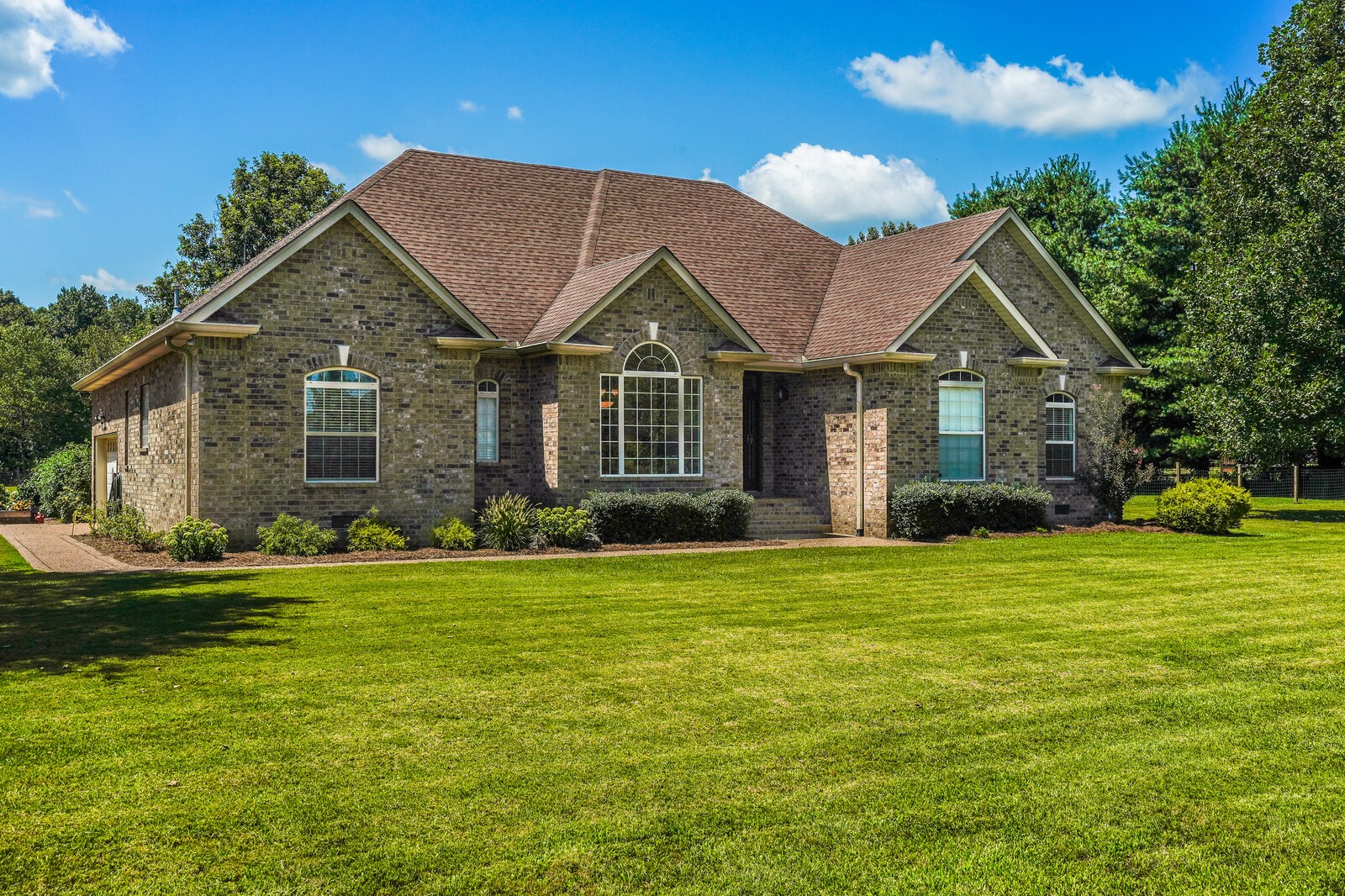 4221 Mt Zion Road Springfield, TN 37172 - Photo 2 of 36 a front view of a house with a garden and trees