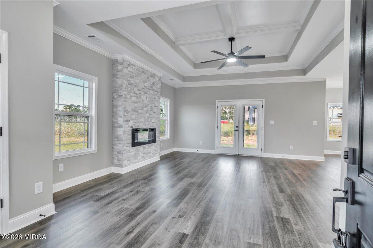 208 Eric Court Byron, GA 31008 - Photo 12 of 57 a view of an empty room with a window and wooden floor