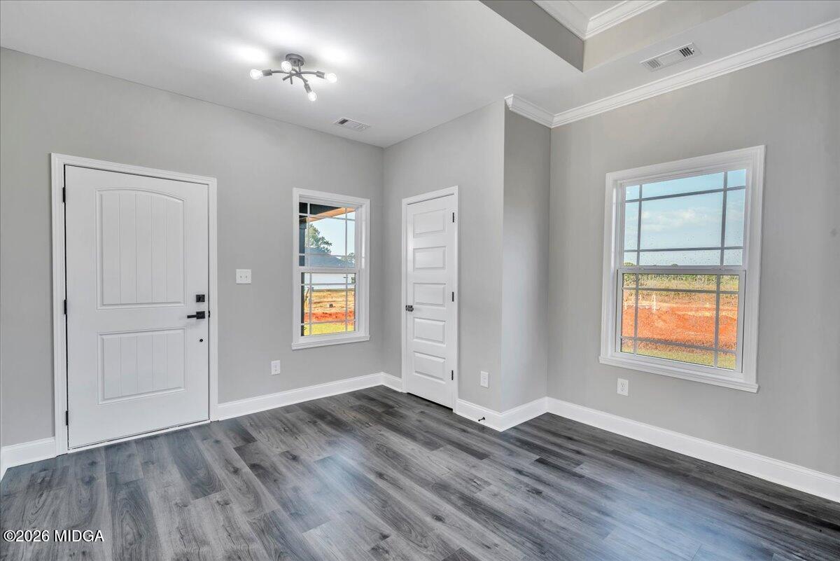 208 Eric Court Byron, GA 31008 - Photo 13 of 57 an empty room with wooden floor and windows