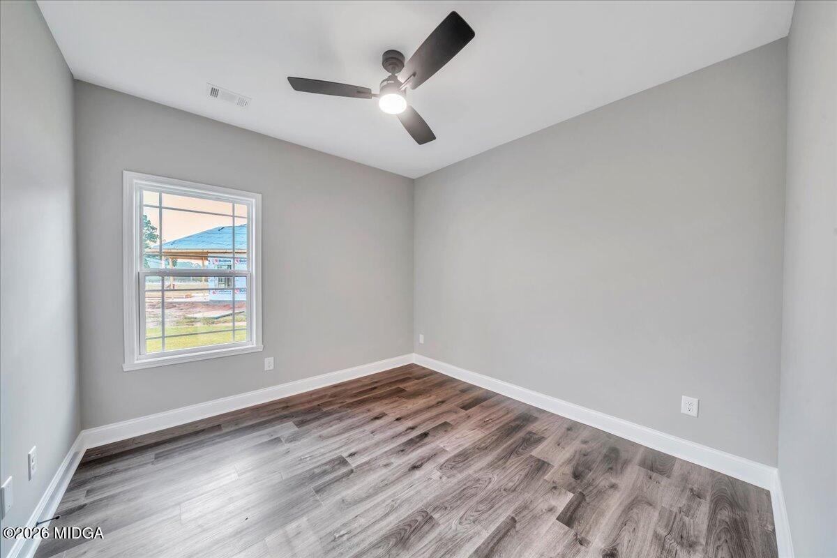 208 Eric Court Byron, GA 31008 - Photo 42 of 57 an empty room with wooden floor and windows