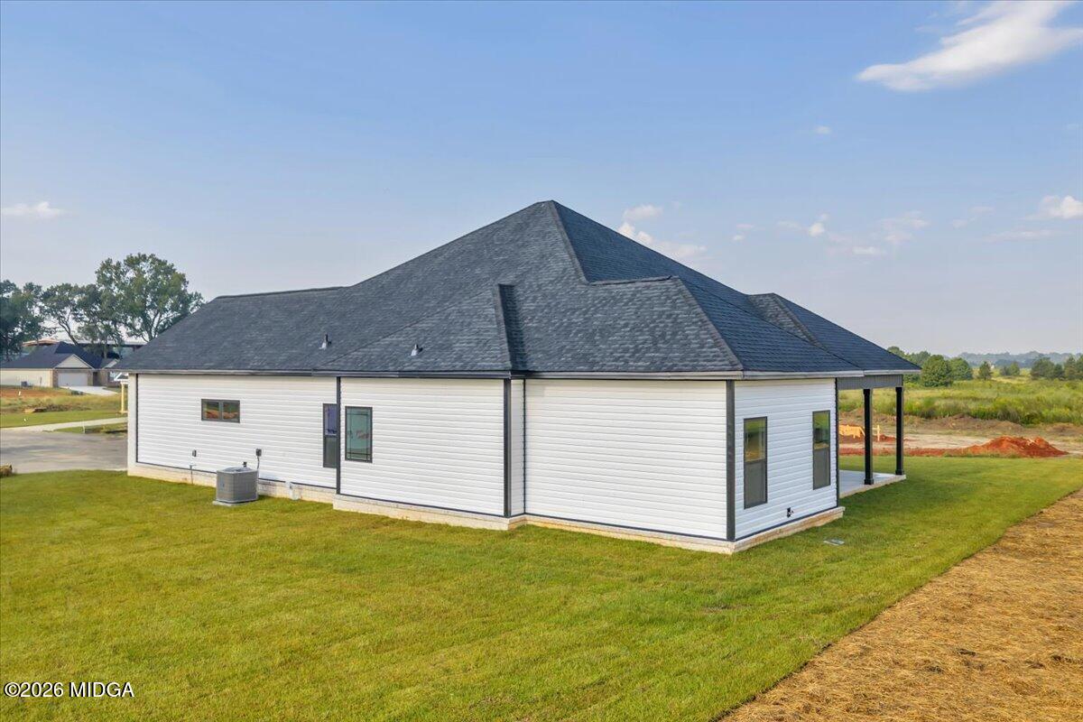 208 Eric Court Byron, GA 31008 - Photo 9 of 57 a backyard of a house with table and chairs under an umbrella