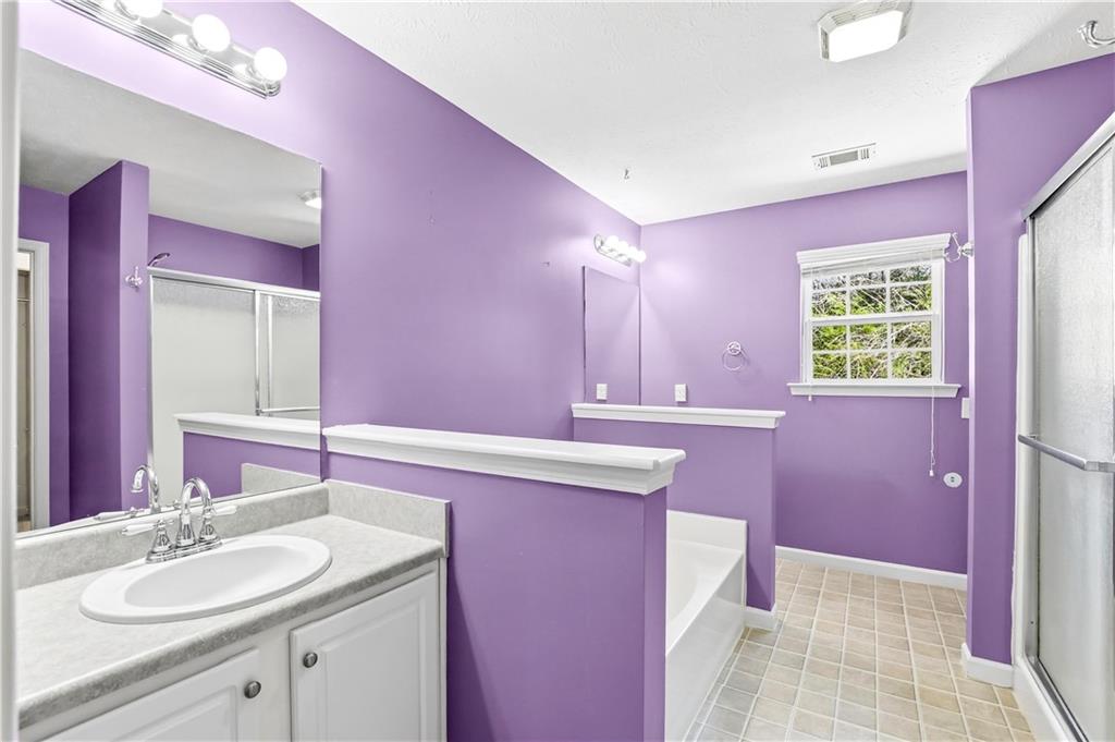 5976 Bowers Road Stone Mountain, GA 30087 - Photo 13 of 29 a bathroom with a sink a vanity and a mirror