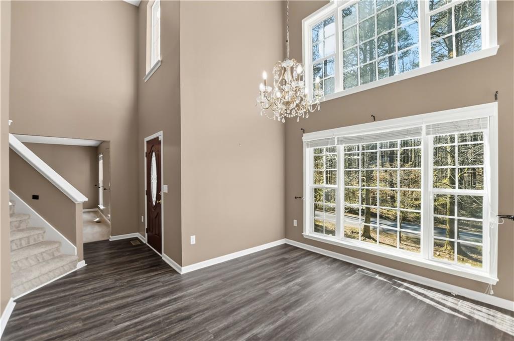 5976 Bowers Road Stone Mountain, GA 30087 - Photo 2 of 29 a view of an empty room with wooden floor and a window