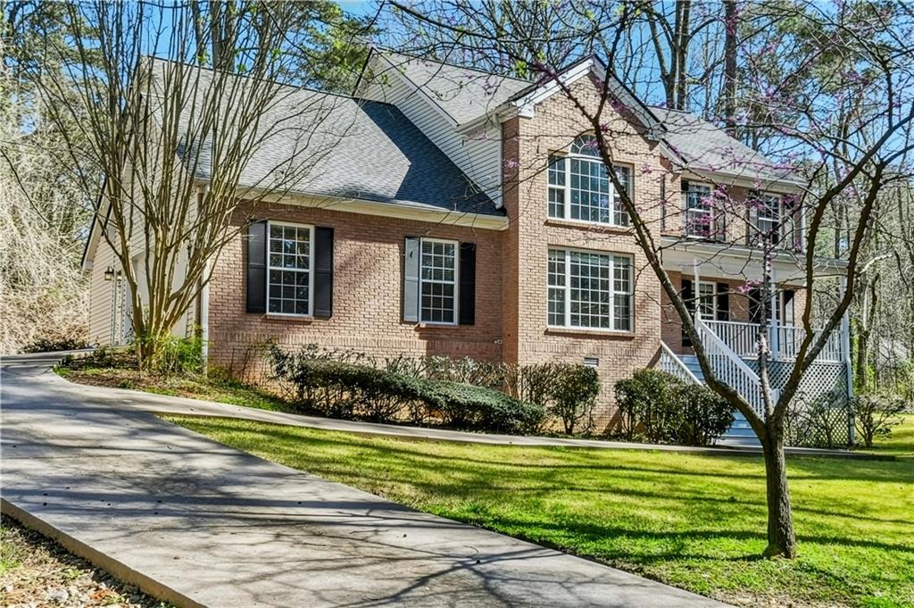 5976 Bowers Road Stone Mountain, GA 30087 - Photo 23 of 29 a front view of a house with a garden