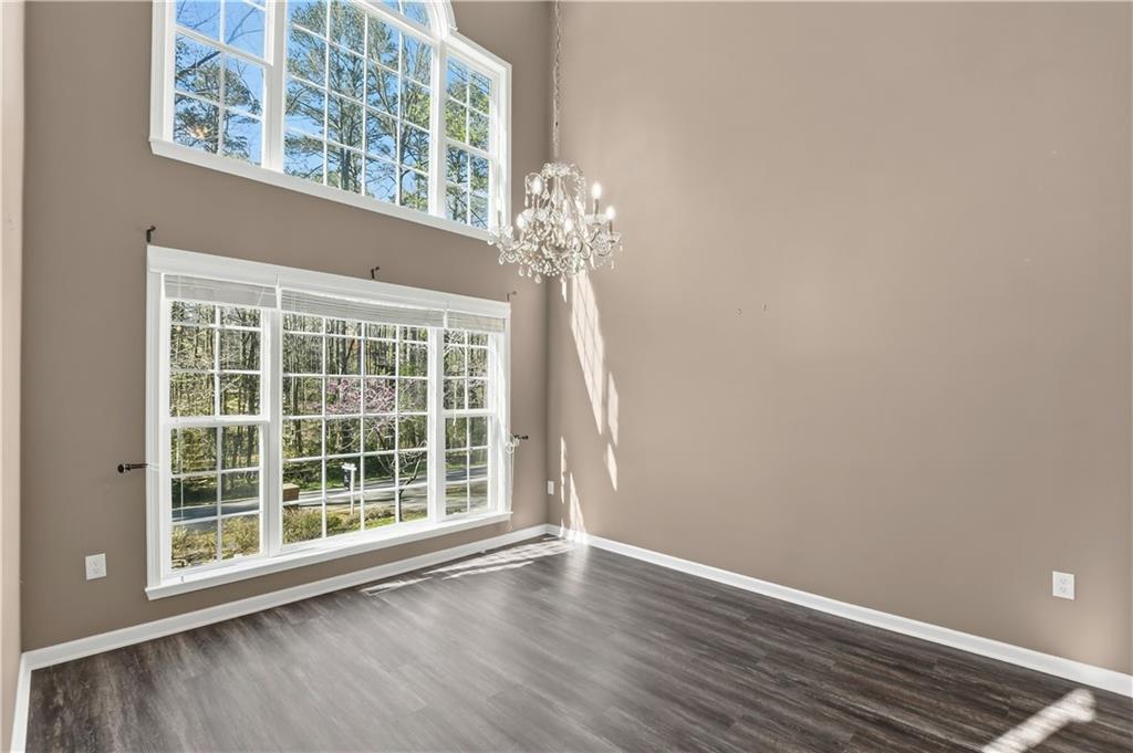 5976 Bowers Road Stone Mountain, GA 30087 - Photo 4 of 29 an empty room with wooden floor and a window