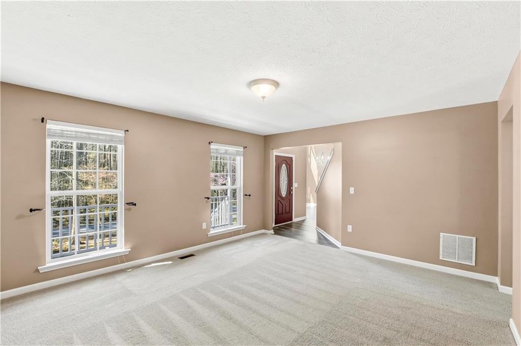 5976 Bowers Road Stone Mountain, GA 30087 - Photo 5 of 29 an empty room with windows