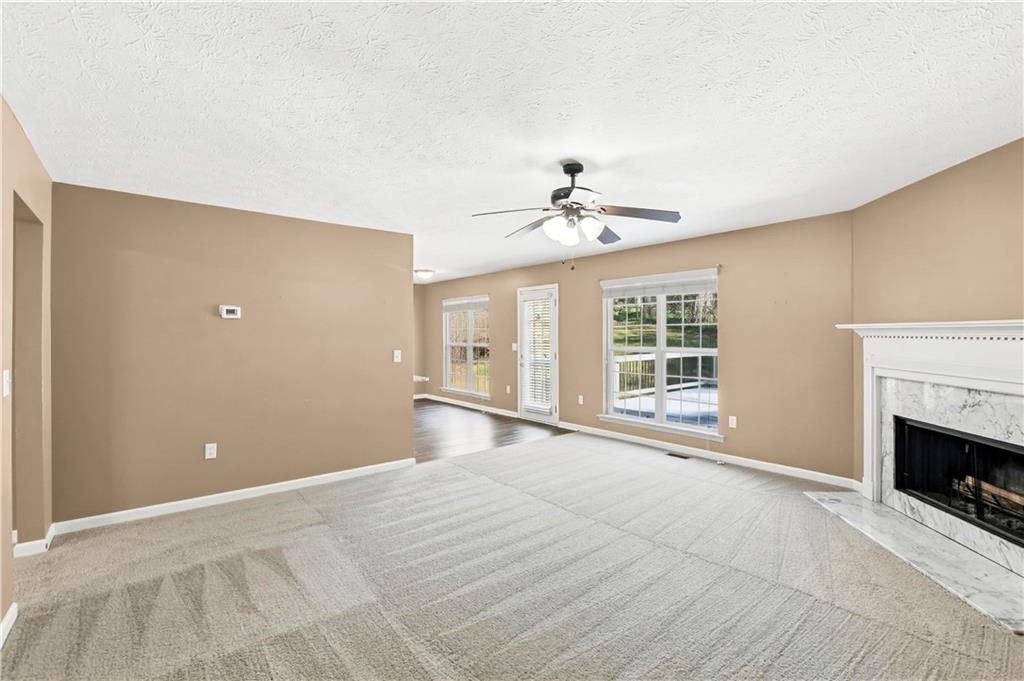 5976 Bowers Road Stone Mountain, GA 30087 - Photo 9 of 29 a view of an empty room with a fireplace and a window