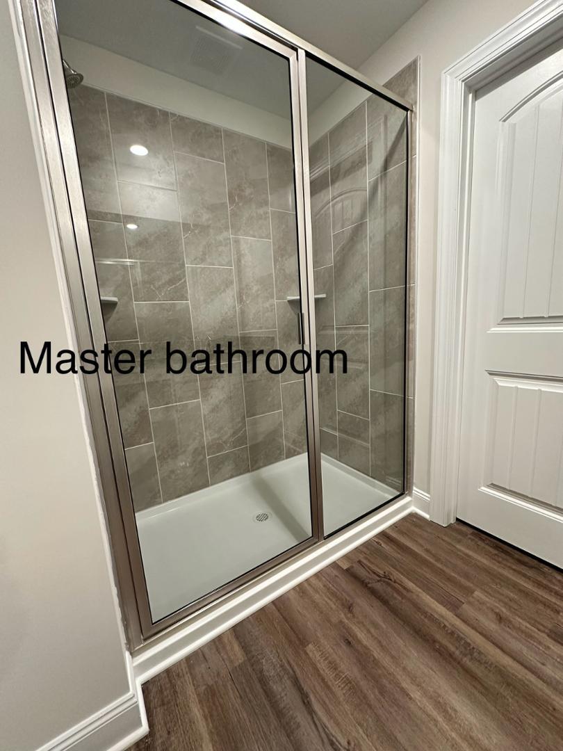 6931 Point Bar Place Raleigh, NC 27616 - Photo 9 of 13 a bathroom with a glass door shower