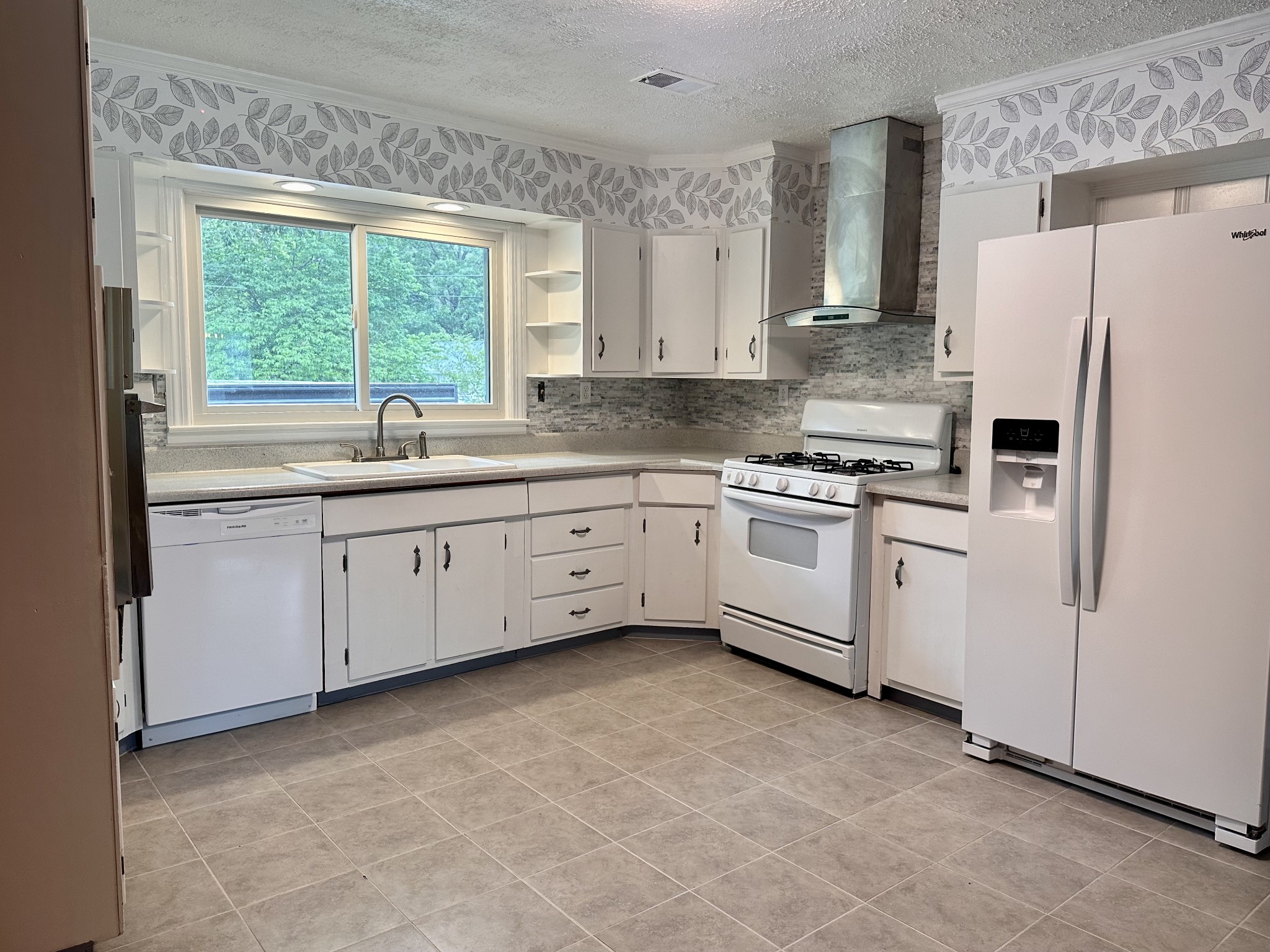 912 Hills Chapel Road Manchester, TN 37355 - Photo 6 of 23 a kitchen with white cabinets and white appliances