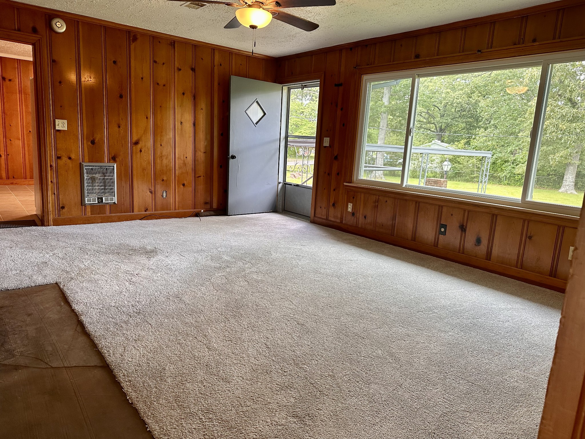 912 Hills Chapel Road Manchester, TN 37355 - Photo 9 of 23 an empty room with windows chandelier and front door