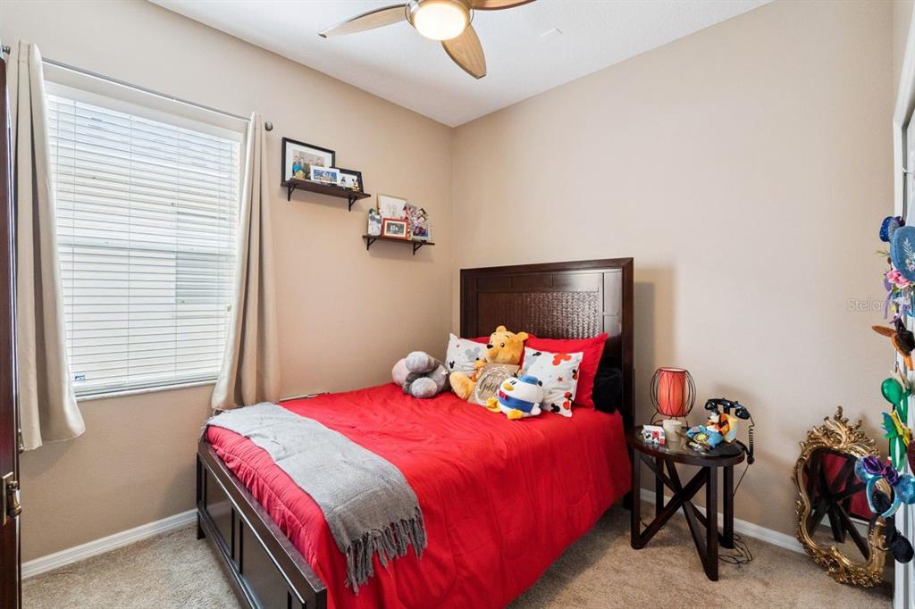 8484 Dover View Lane Orlando, FL 32829 - Photo 15 of 41 a bedroom with a bed and a chandelier