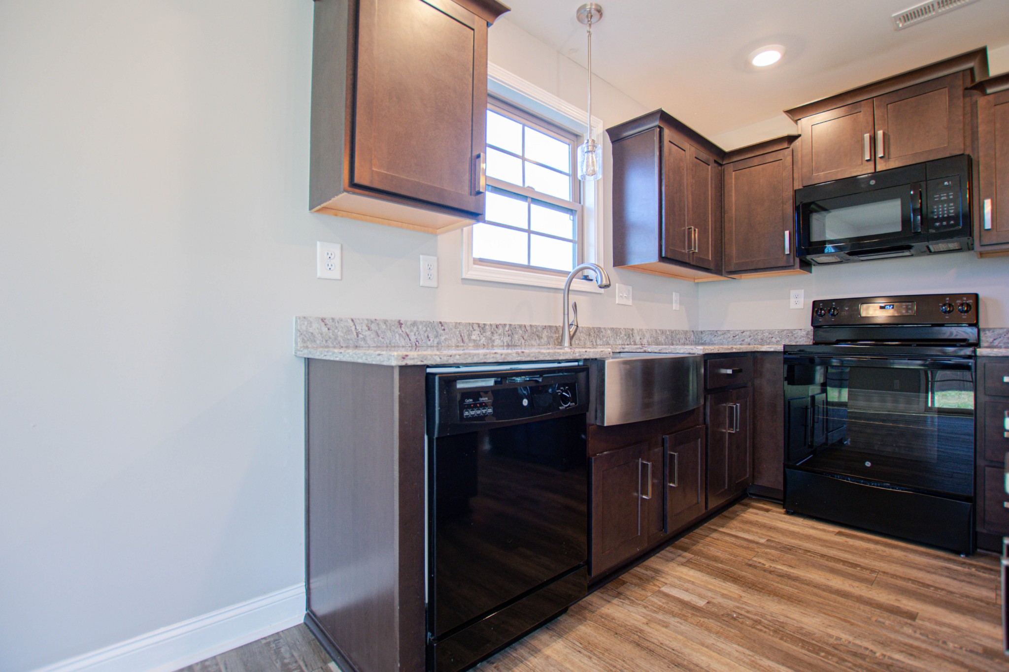 104 Schroer Road Clarksville, TN 37042 - Photo 9 of 25 a kitchen with stainless steel appliances granite countertop a stove and a microwave
