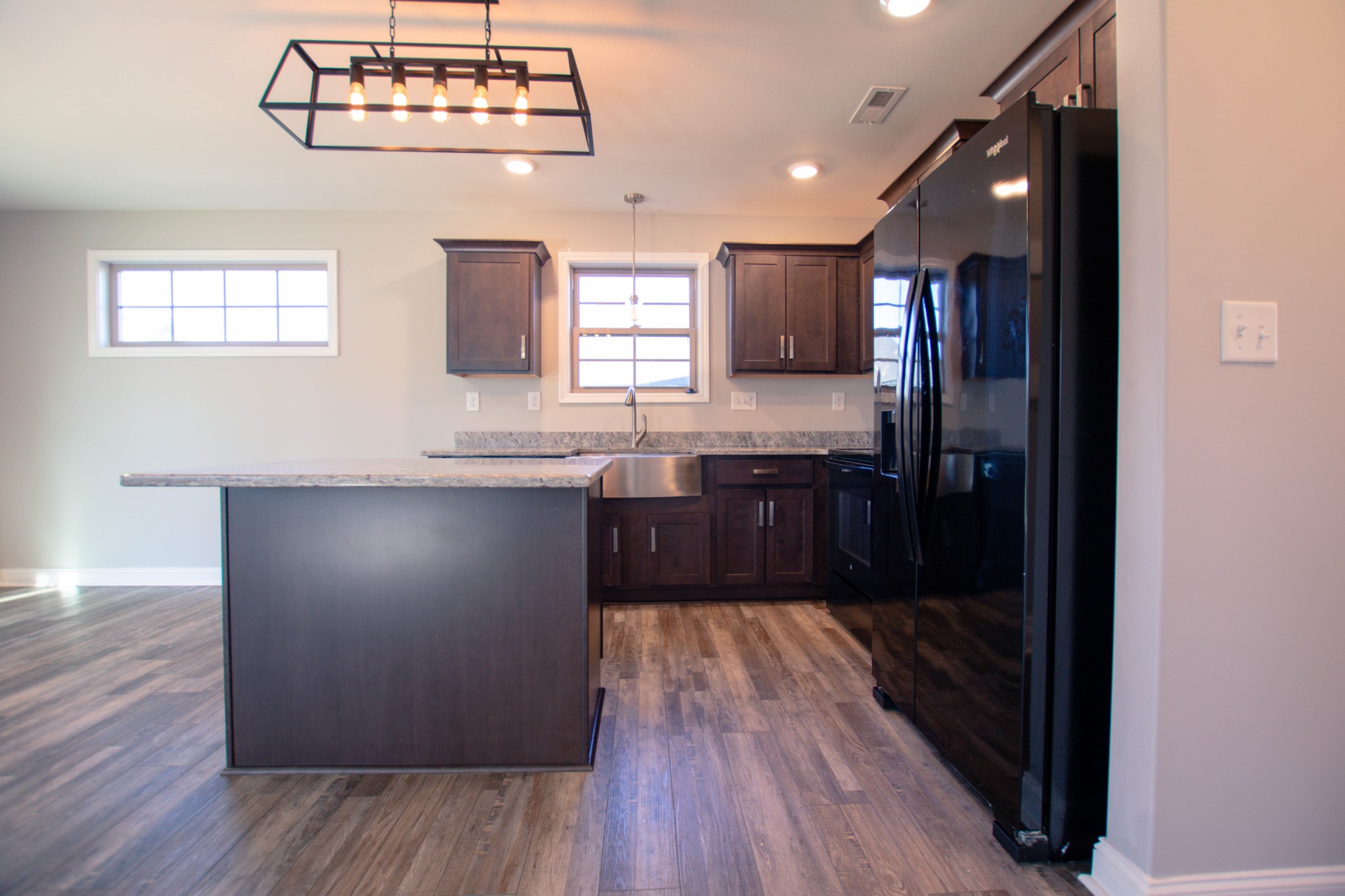 104 Schroer Road Clarksville, TN 37042 - Photo 10 of 25 a kitchen with stainless steel appliances granite countertop a refrigerator a sink dishwasher a stove and a dining table with wooden floor