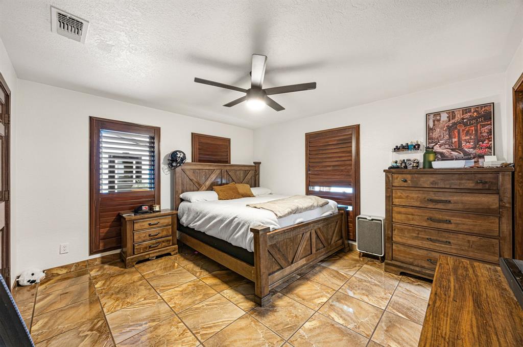 41 Graham Lane Lucas, TX 75002 - Photo 8 of 17 a bedroom with a bed and a chandelier