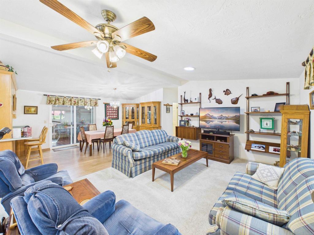 18218 Paradise Mountain Road, Unit 220 Valley Center, CA 92082 - Photo 29 of 48 a living room with furniture kitchen view and a chandelier