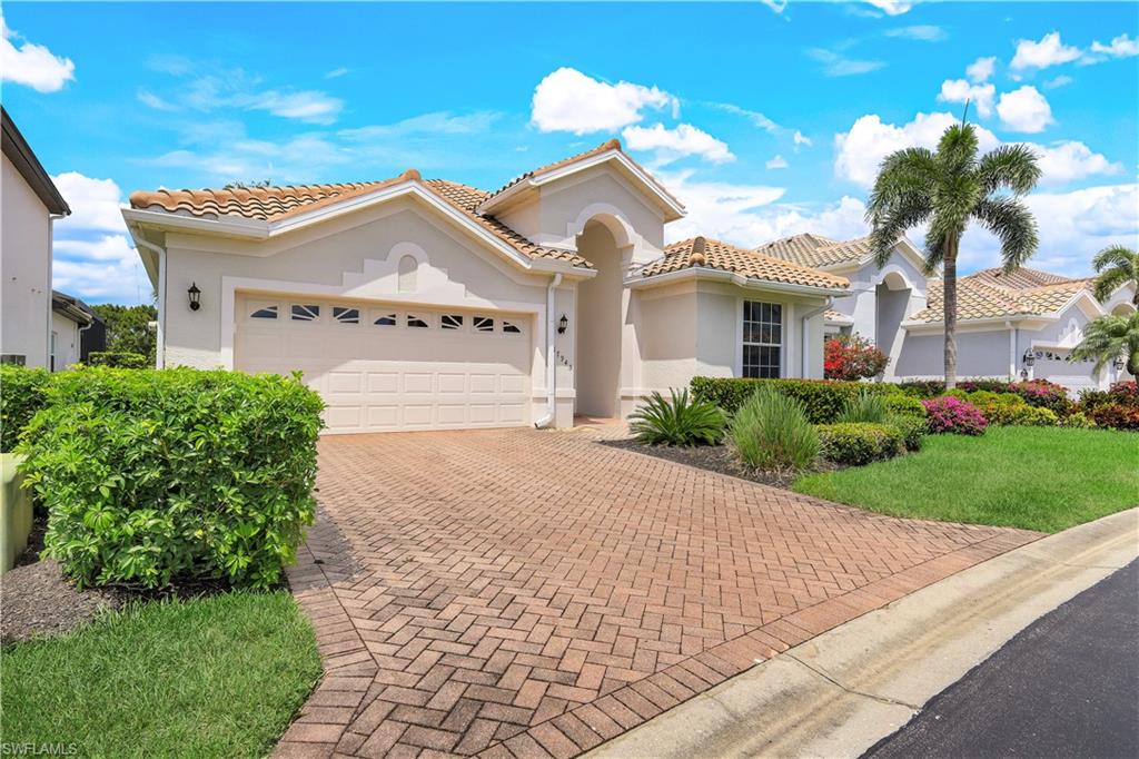 17945 Modena Road Miromar Lakes, FL 33913 - Photo 1 of 24 a view of a white house with a yard and potted plants