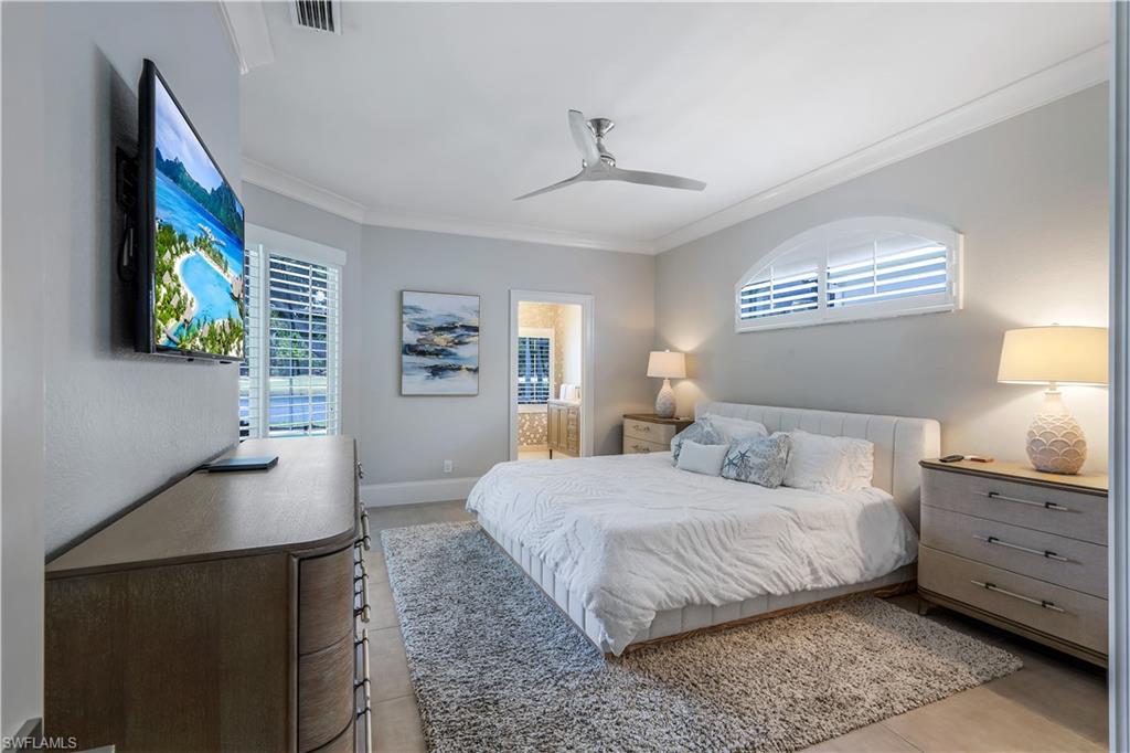 17945 Modena Road Miromar Lakes, FL 33913 - Photo 11 of 24 a bedroom with a bed and a desk