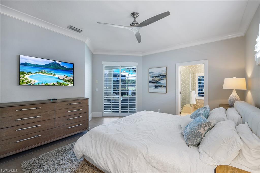 17945 Modena Road Miromar Lakes, FL 33913 - Photo 12 of 24 a bedroom with a bed and a large window