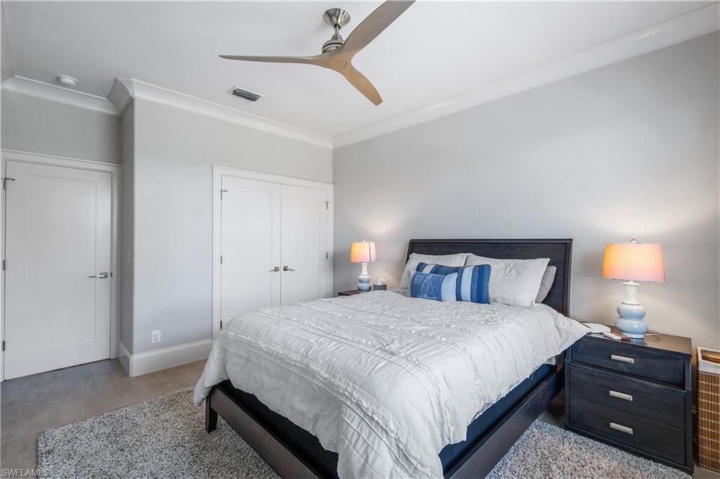 17945 Modena Road Miromar Lakes, FL 33913 - Photo 14 of 24 a bedroom with a bed and a lamp