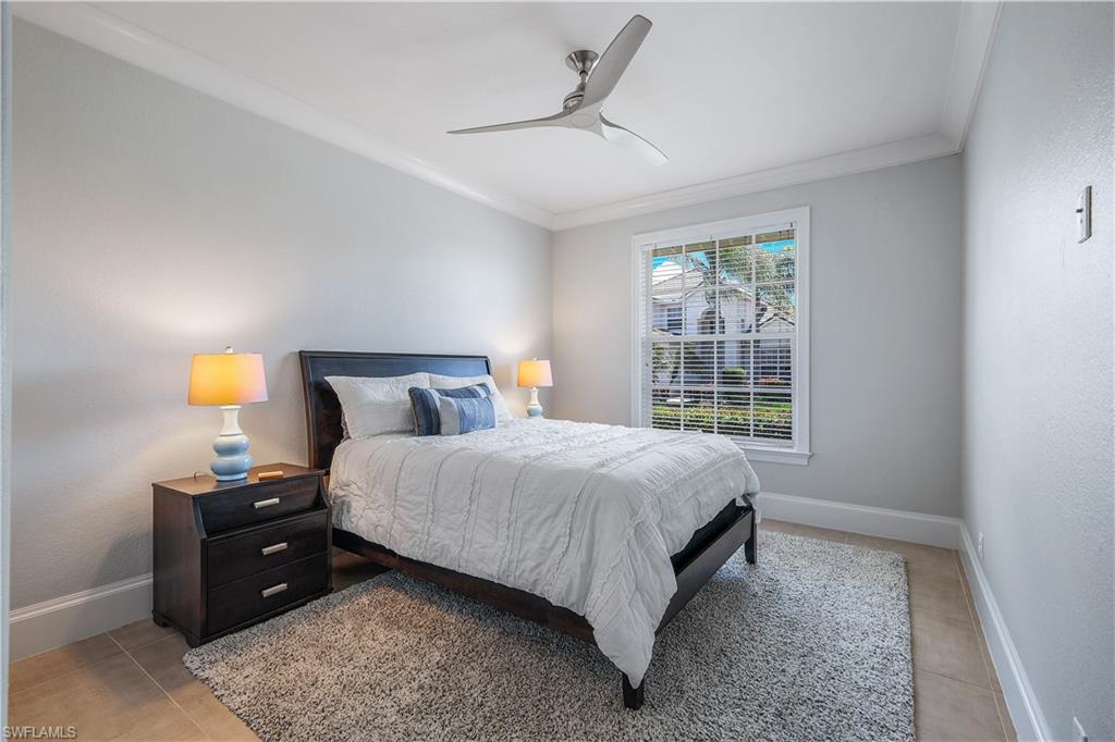 17945 Modena Road Miromar Lakes, FL 33913 - Photo 15 of 24 a bedroom with a bed and a window
