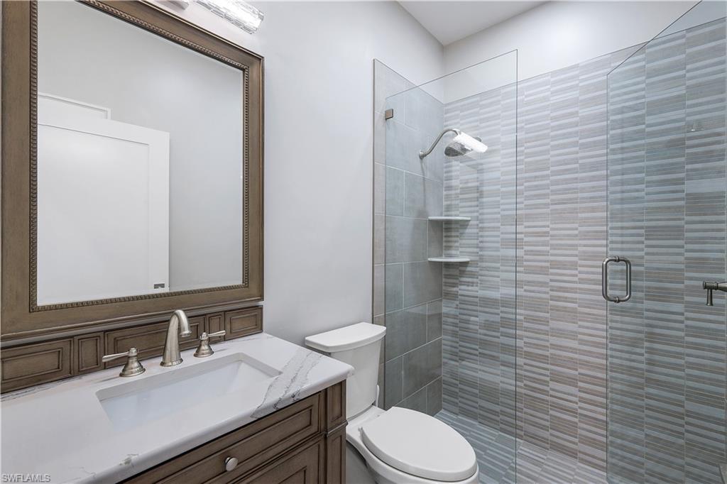 17945 Modena Road Miromar Lakes, FL 33913 - Photo 16 of 24 a bathroom with a sink a toilet and shower