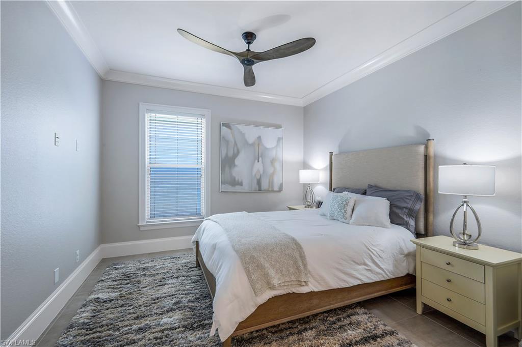 17945 Modena Road Miromar Lakes, FL 33913 - Photo 17 of 24 a bedroom with a large bed and a window