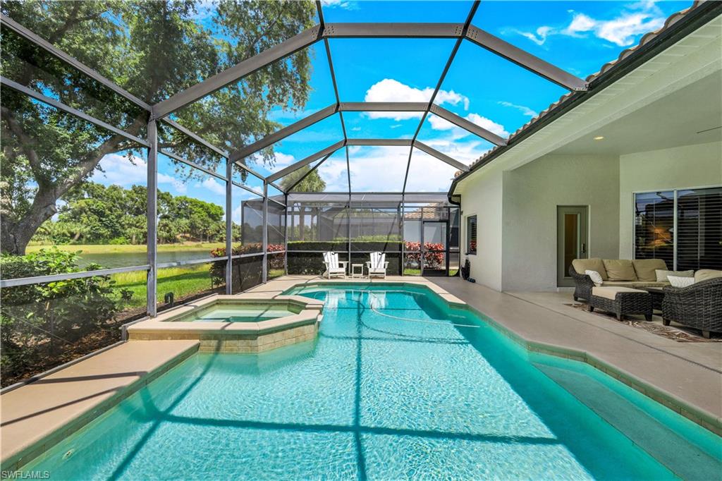 17945 Modena Road Miromar Lakes, FL 33913 - Photo 22 of 24 a view of a backyard with a patio and fire pit