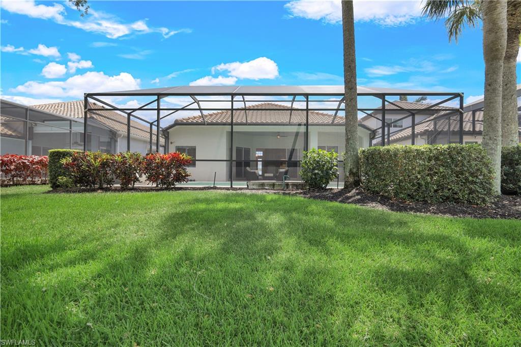 17945 Modena Road Miromar Lakes, FL 33913 - Photo 23 of 24 a front view of a house with garden