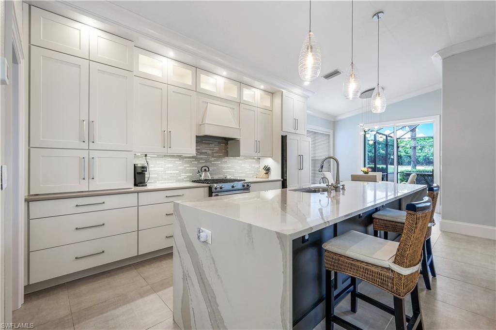17945 Modena Road Miromar Lakes, FL 33913 - Photo 6 of 24 a kitchen with appliances a sink and cabinets